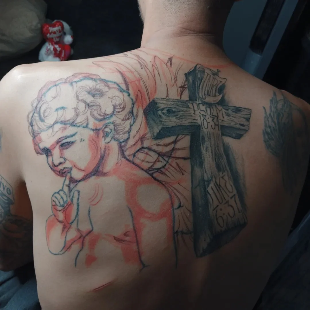 Angel with cross American traditional tattoo on the back by Alfredo Sosa