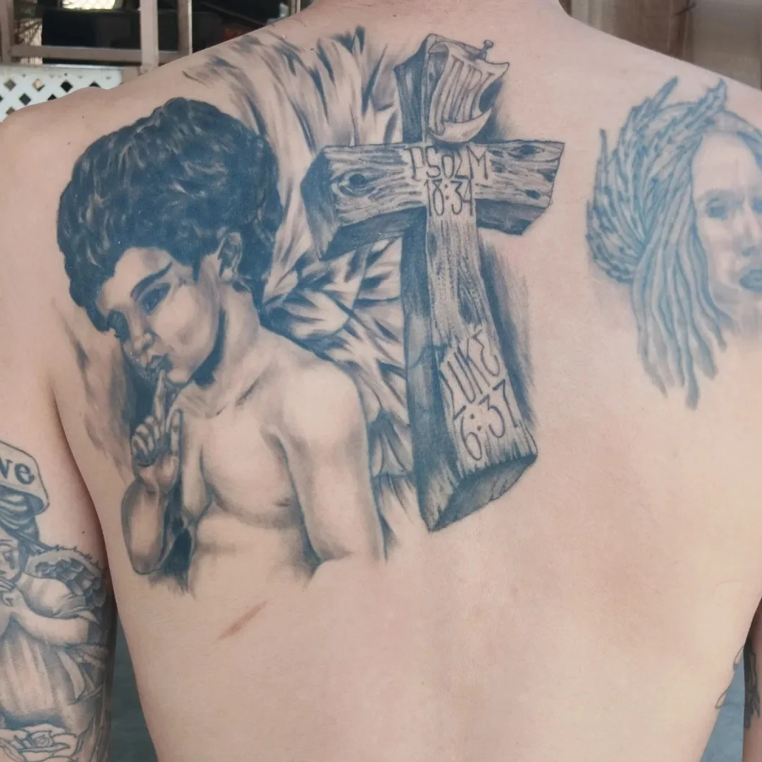Angel with cross realism tattoo on the back by Alfredo Sosa