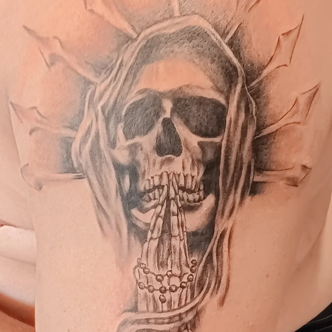 Praying skull realism tattoo on the chest by Alfredo Sosa