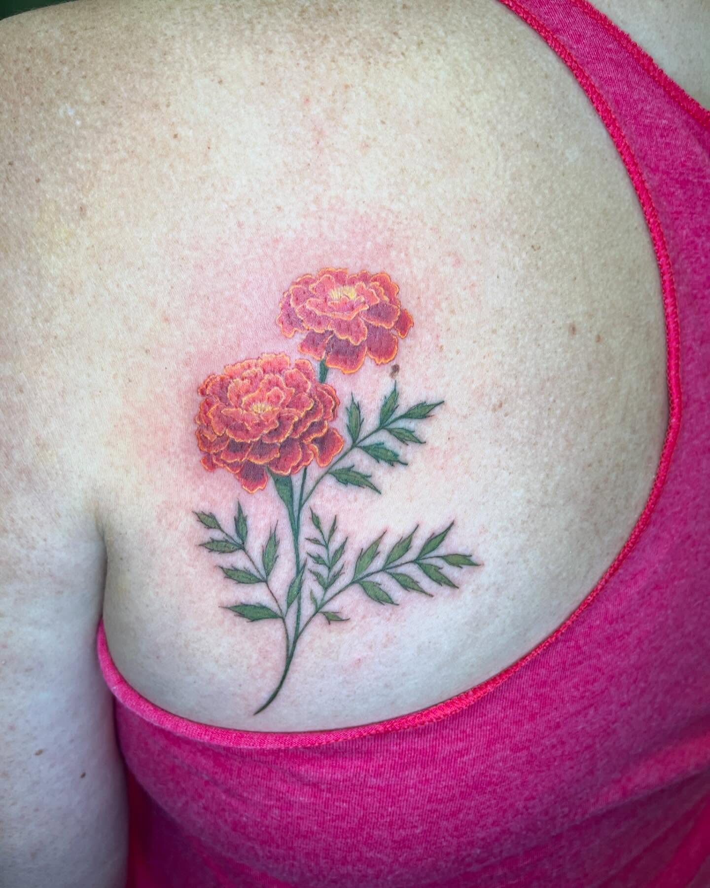Marigolds realism tattoo on the shoulder by Tattoos by Gina Palladino
