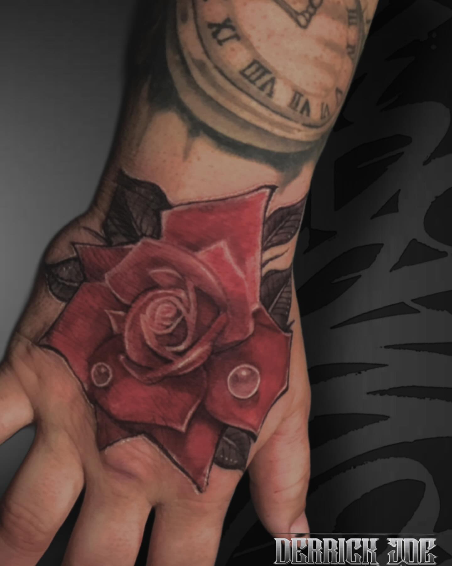 Red rose realism tattoo on the hand by Derrick Joe tattoos