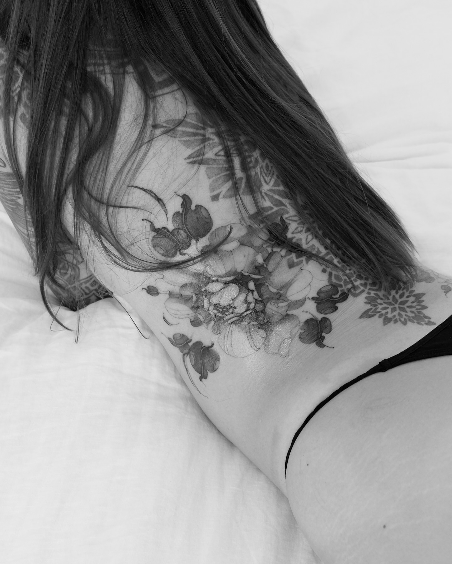Floral arrangement black and grey tattoo on the neck by Kate