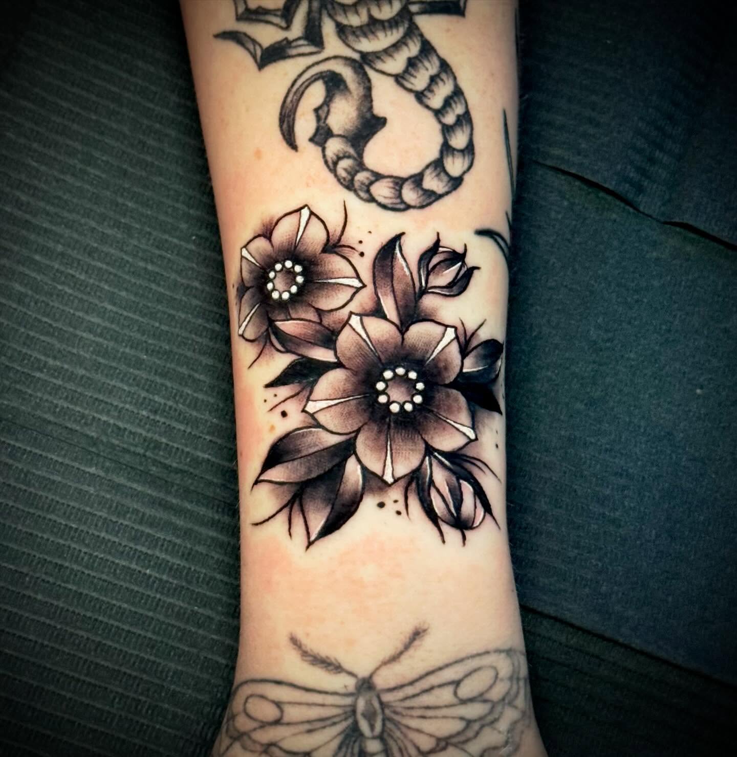 Flowers American traditional tattoo on the forearm by Jeremy Carson