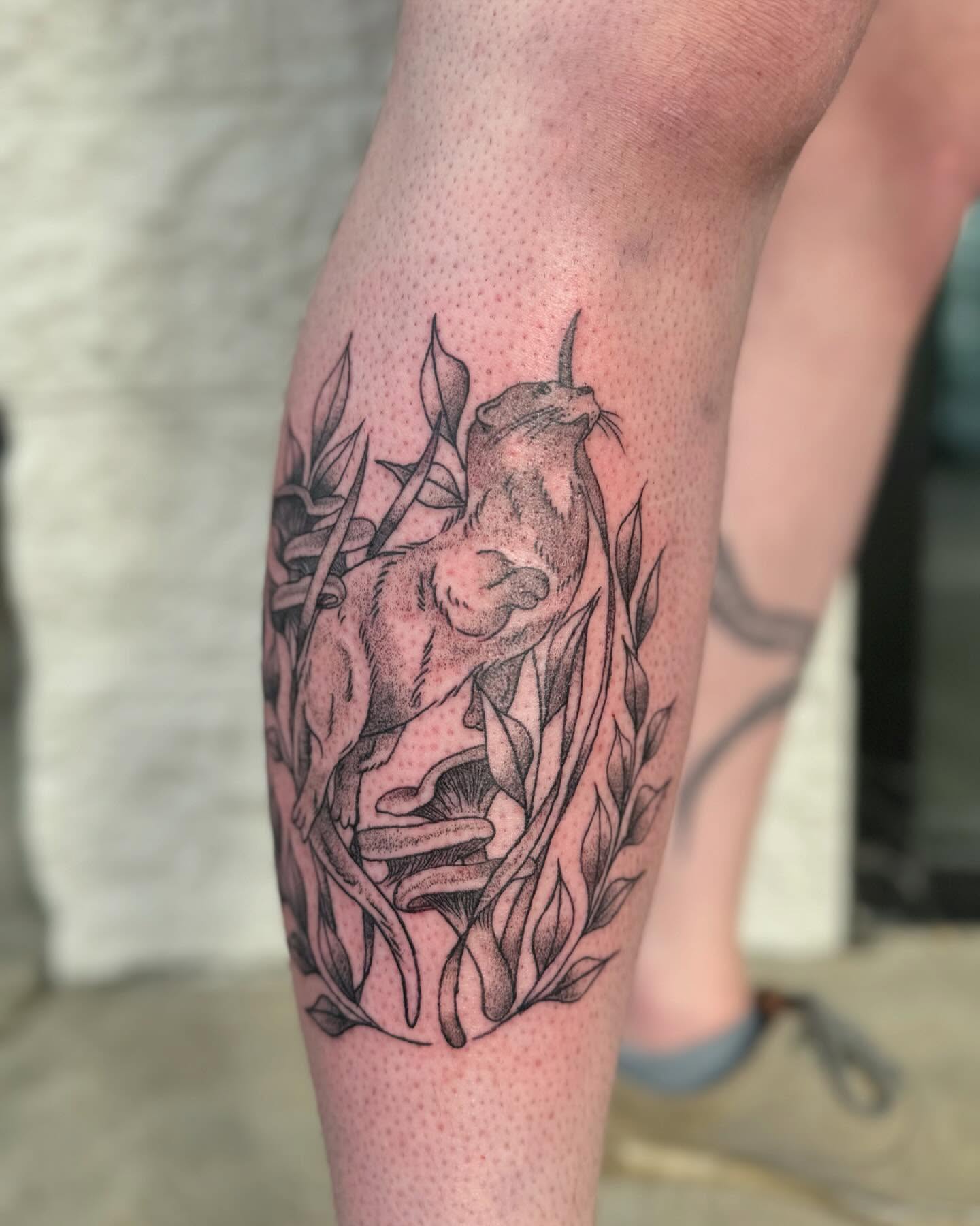 Cat and foliage dotwork tattoo on the forearm by Marissa Losier