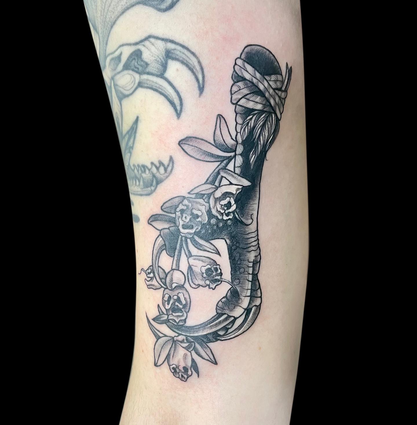 Snake and flowers realism tattoo on the forearm by Antoinette