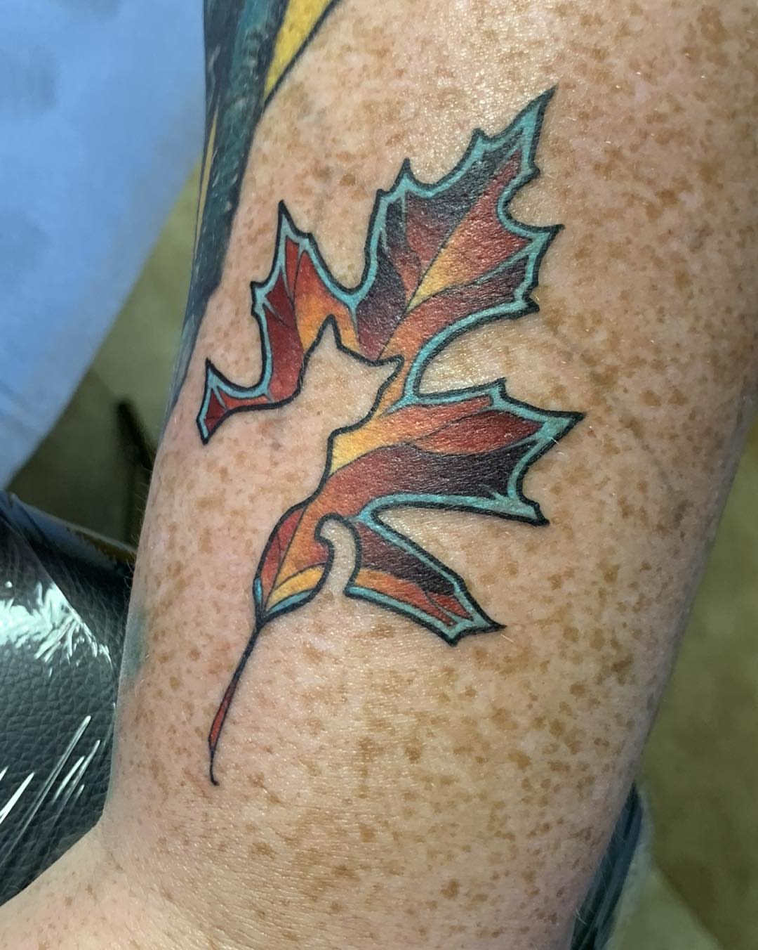 Autumn leaves American traditional tattoo on the forearm by Harper Clark