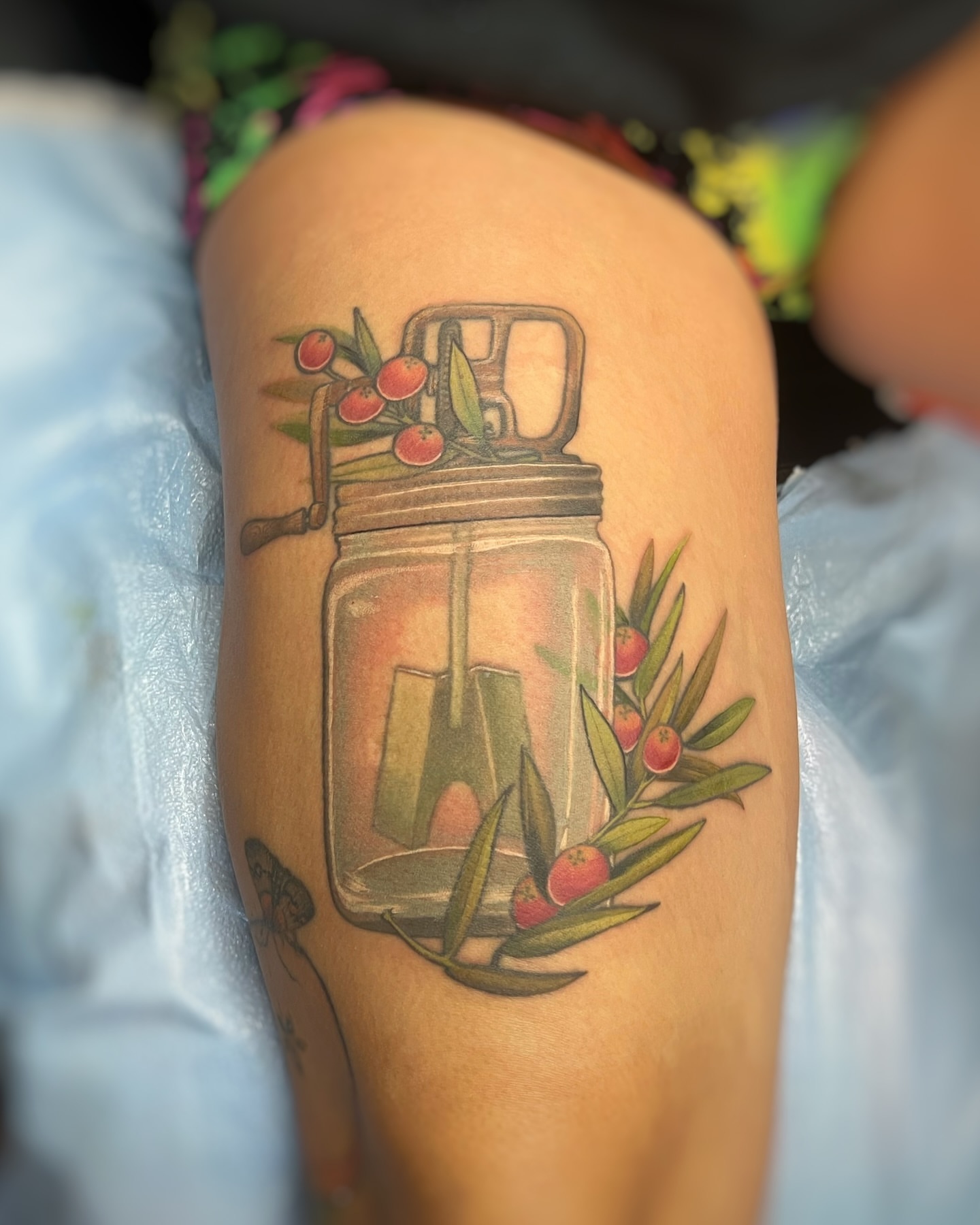 Mason jar with berries realism tattoo on the thigh by sam cedar geller 🐝