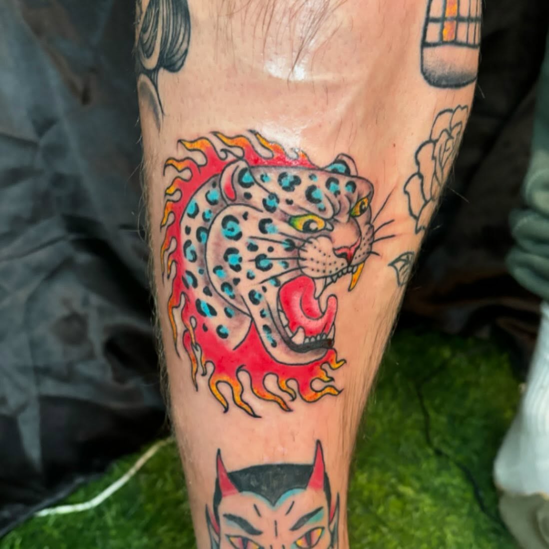 Flaming leopard American traditional tattoo on the forearm by Kimberly Shordon