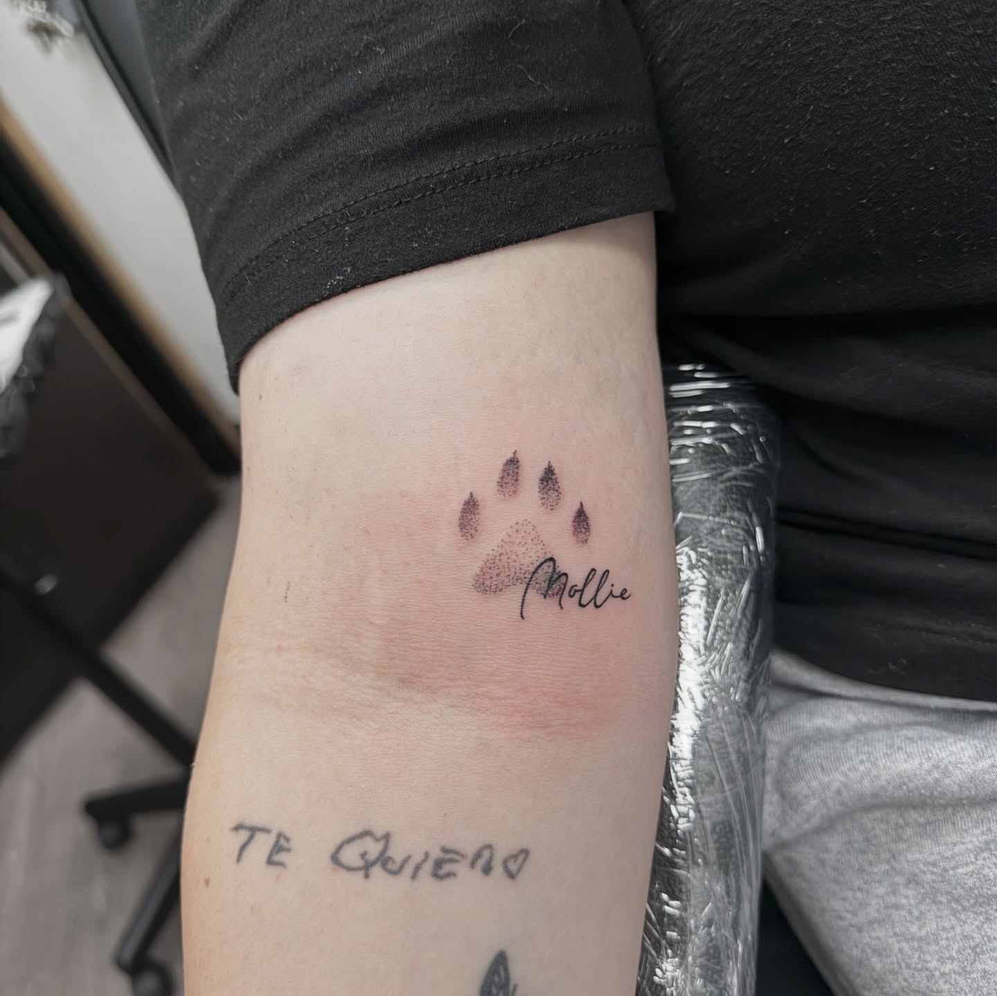 Paw print dotwork tattoo on the forearm by Syd Cheyenne
