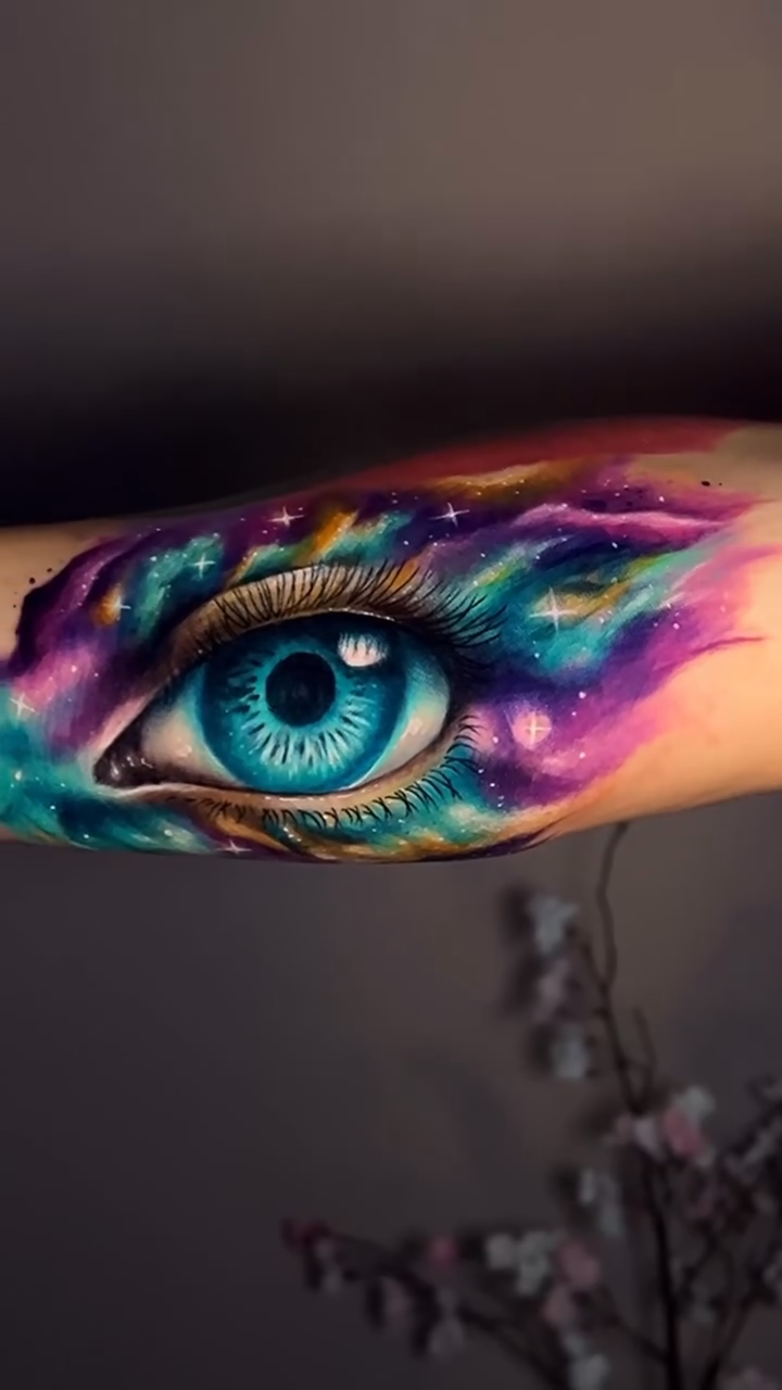 Eye with cosmic background watercolor tattoo on the forearm by Kaly, Manhattan, NYC
