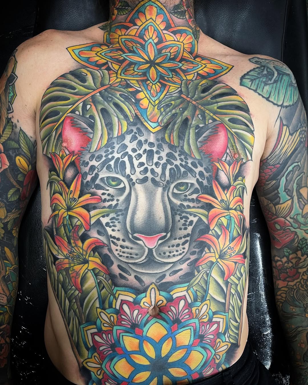Leopard face with flowers and mandala realism tattoo on the chest by Jake Horstman, Dayton, Ohio