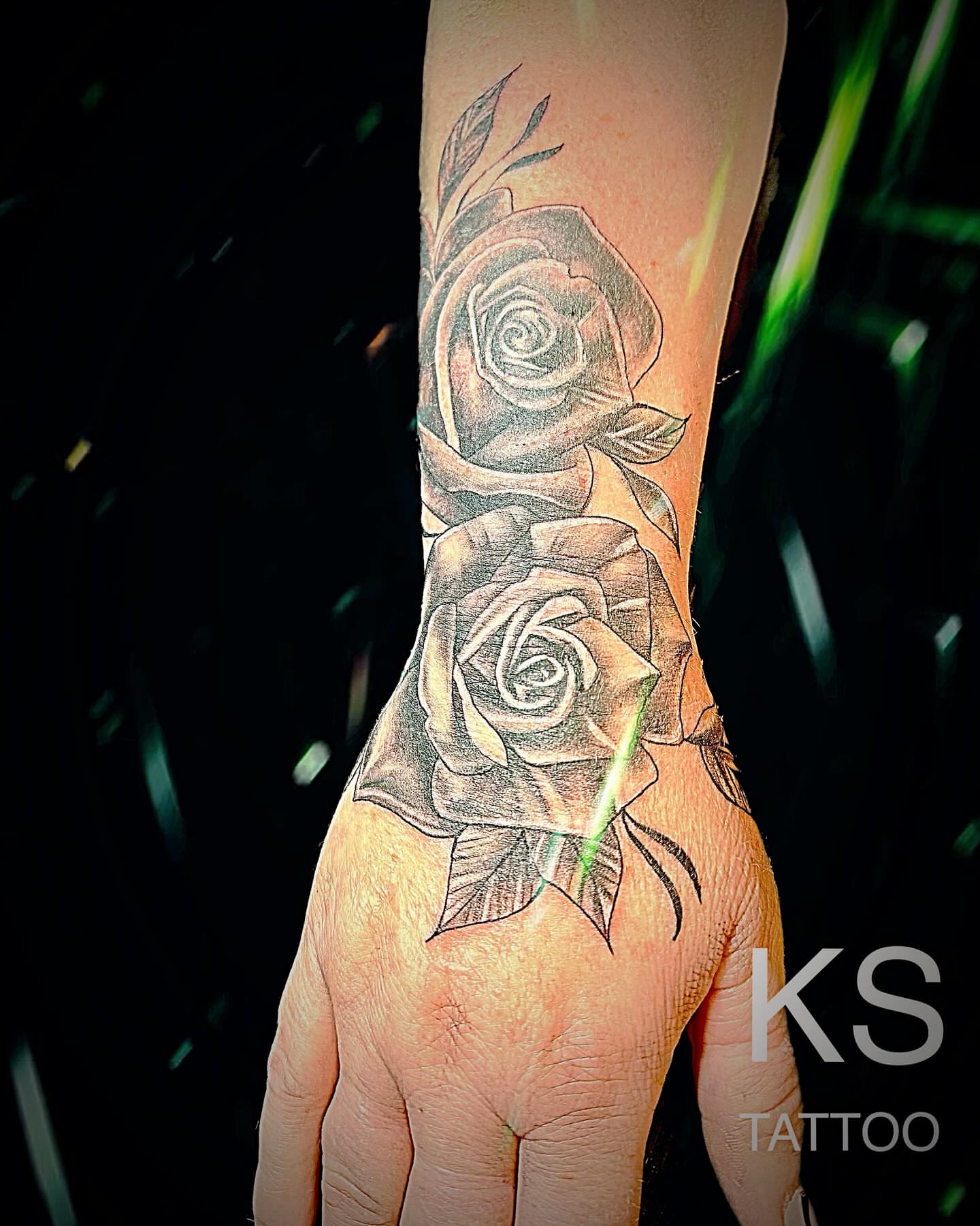 Roses black and grey tattoo on the hand by Karen Smith