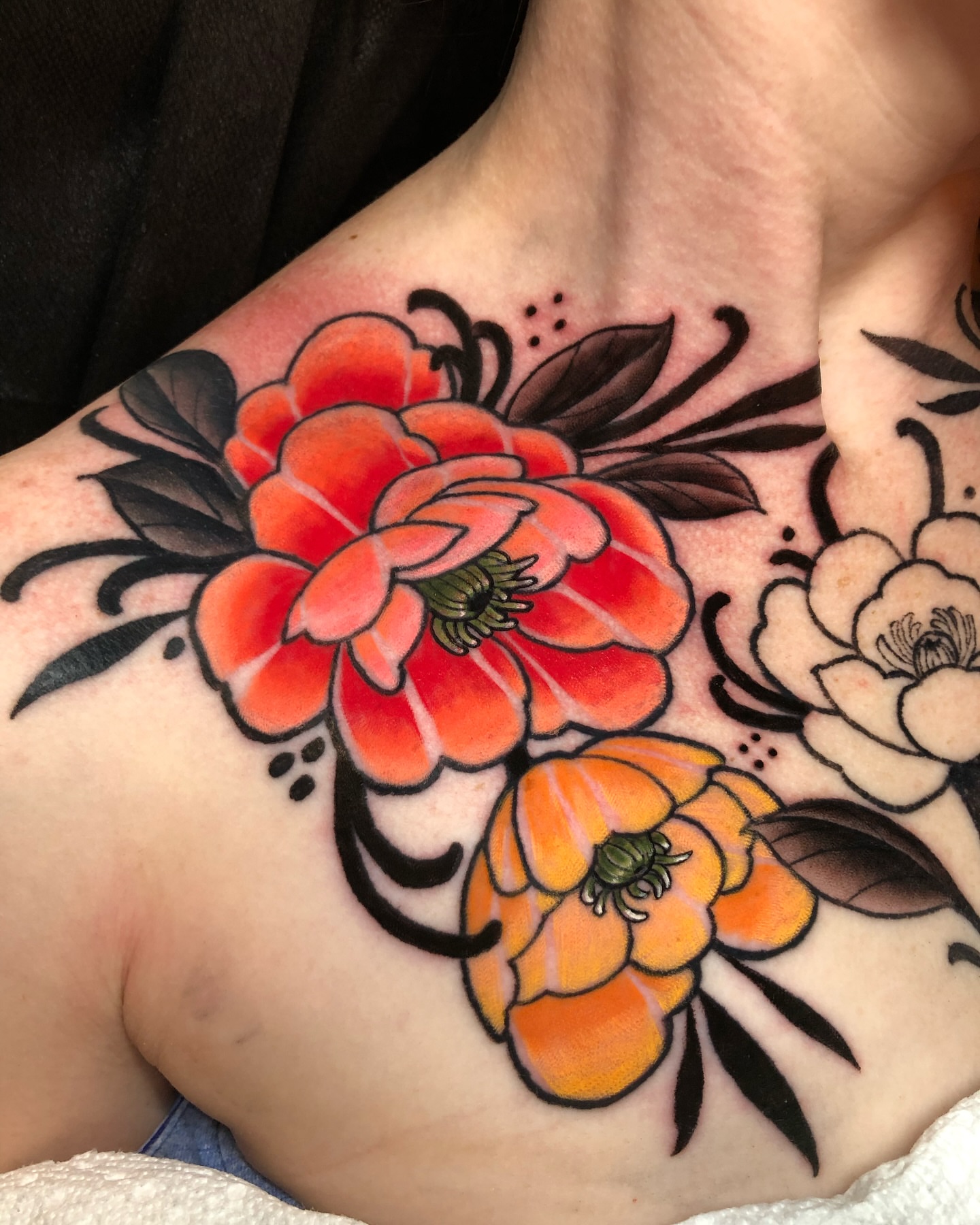 Floral bouquet American traditional tattoo on the chest by Melissa Brown