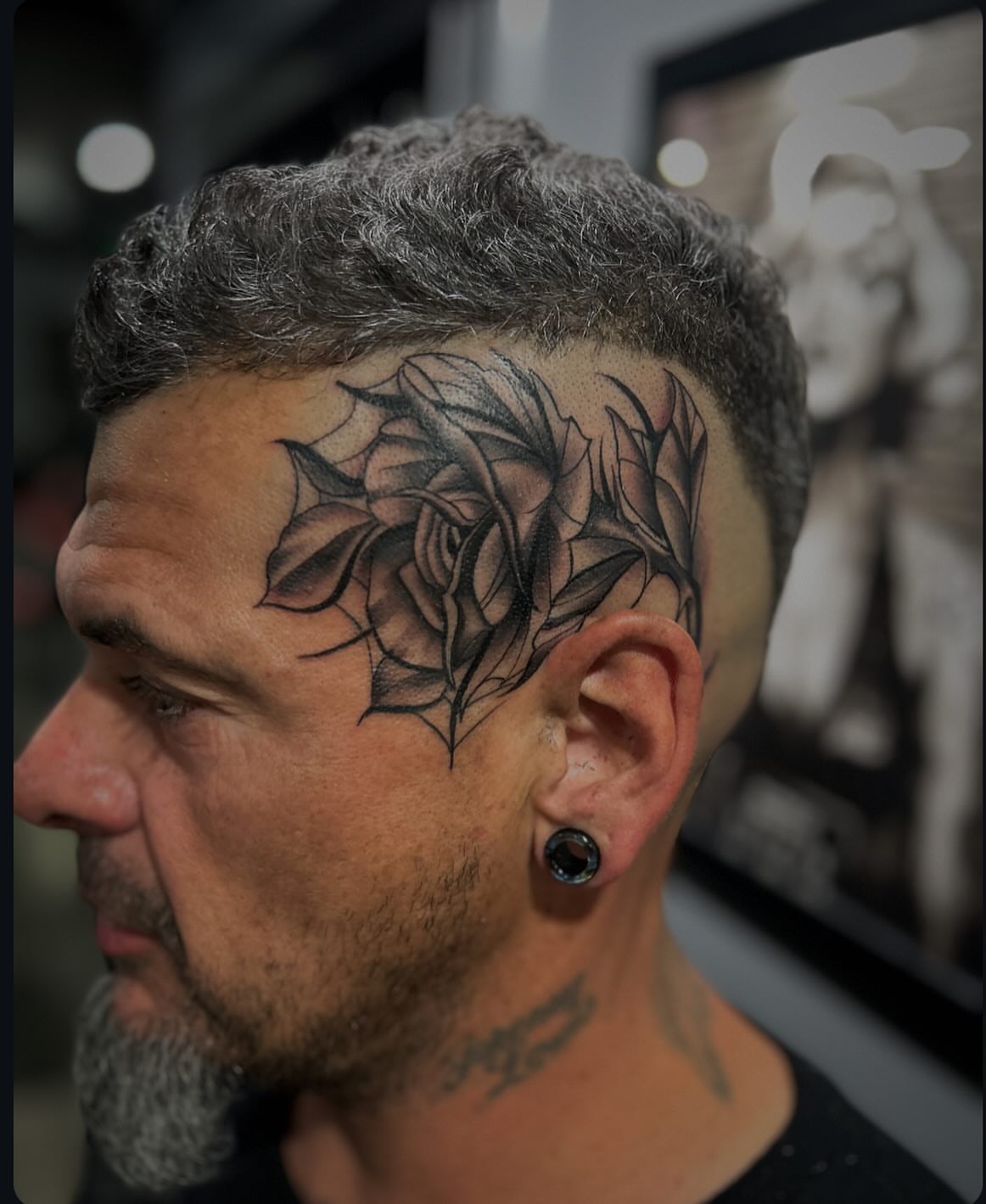 Rose black and grey tattoo on the head by Brian Keith