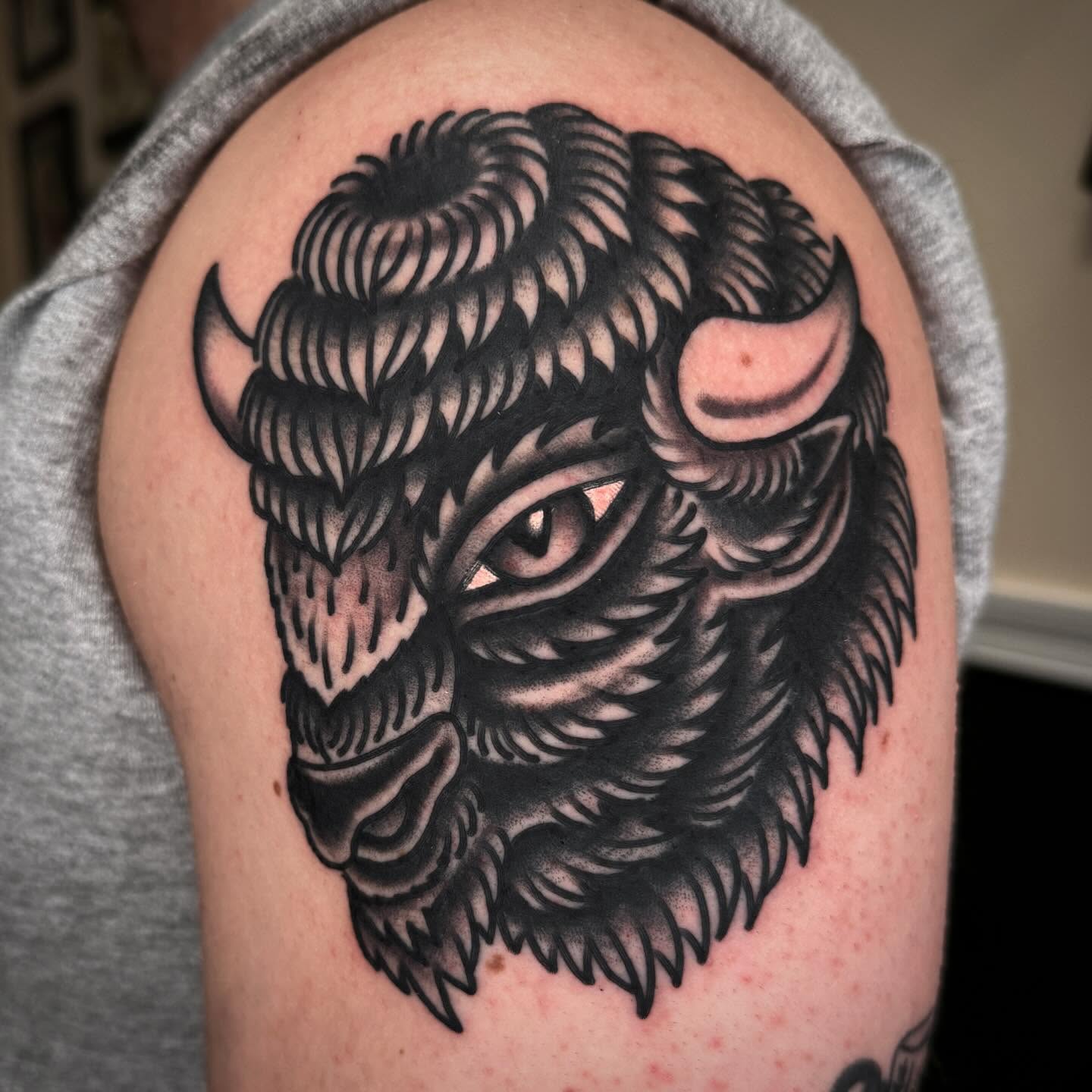 Buffalo head black and grey tattoo on the shoulder by John Lemon