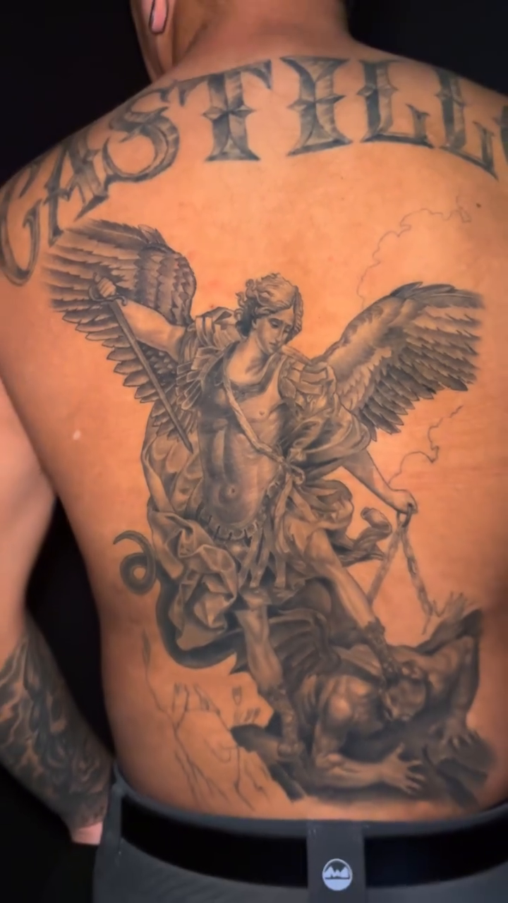 Archangel Michael battling a demon realism tattoo by Ian Vanderwerff