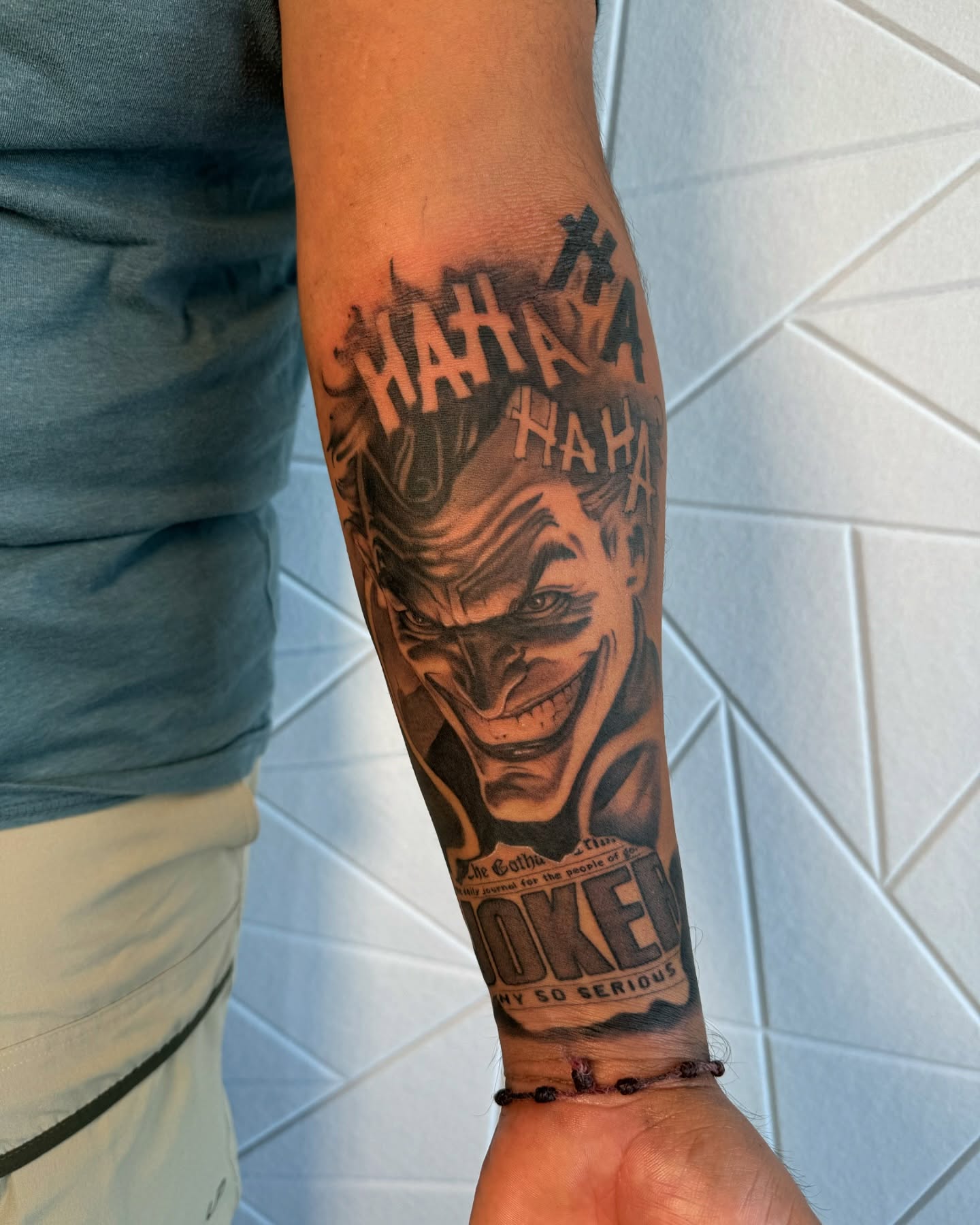 Joker black and grey tattoo on the forearm by Isiah Hall, Whittier, California