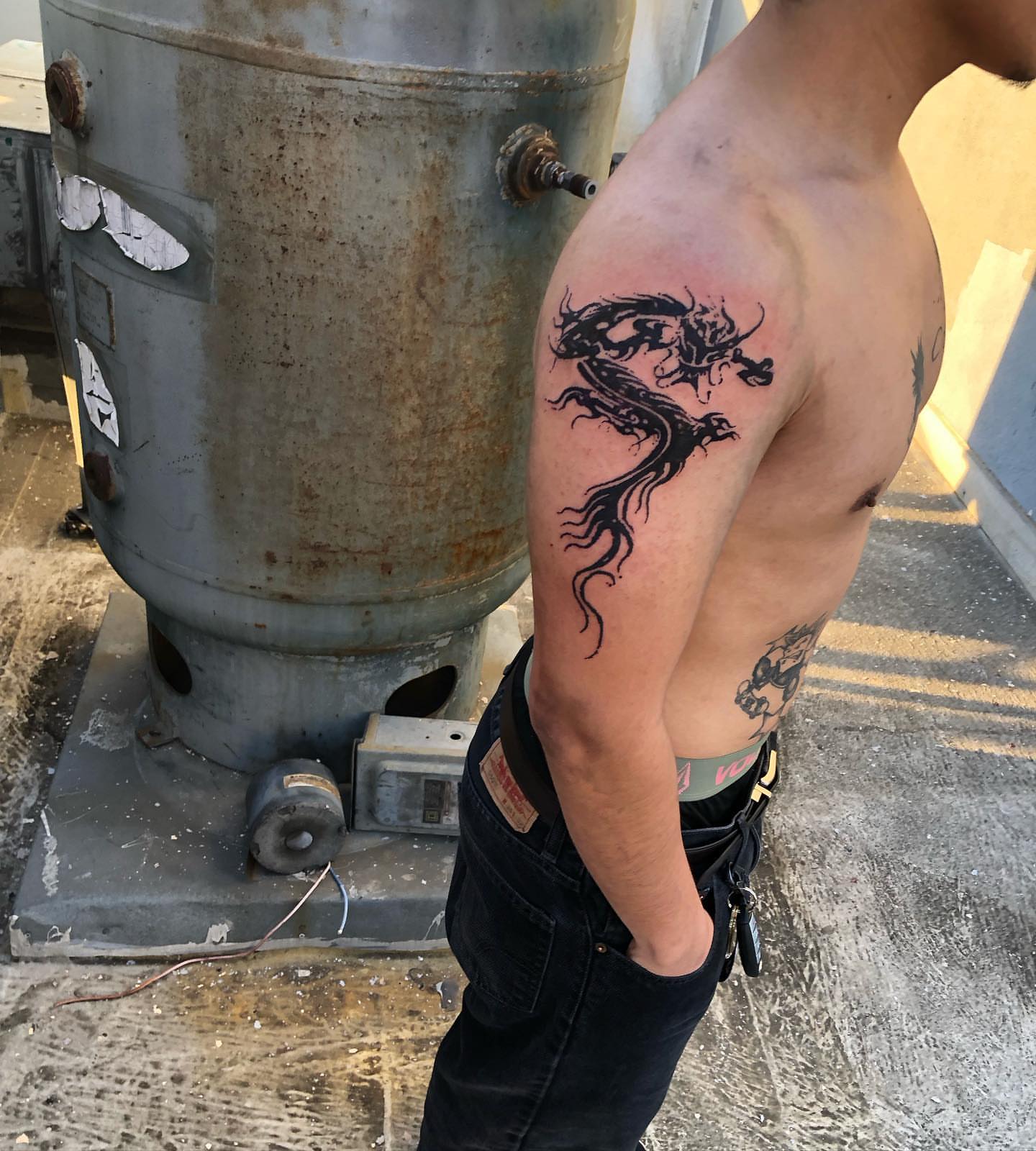 Dragon black and grey tattoo on the shoulder by @emotionalthugtattoo