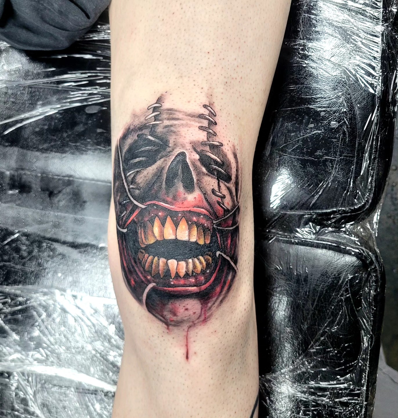 Skull with stitches dark realism tattoo on the forearm by Jentrey McCausland
