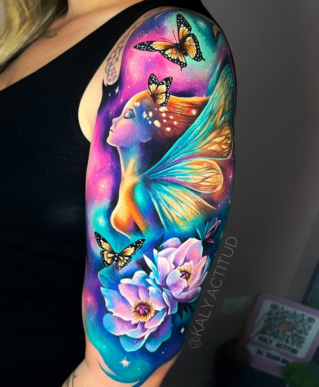 Fairy with butterflies and flowers watercolor tattoo on the upper arm by Kaly, Manhattan, NYC