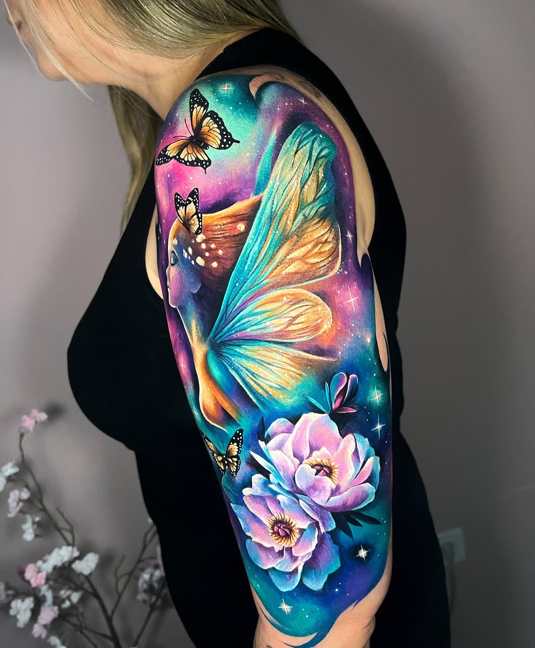 Fairy with butterflies and flowers watercolor tattoo on the upper arm by Kaly, Manhattan, NYC