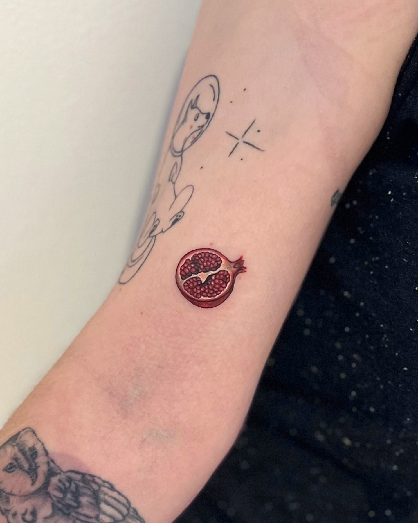 Pomegranate realism tattoo on the forearm by Lynx, Cincinnati, Ohio