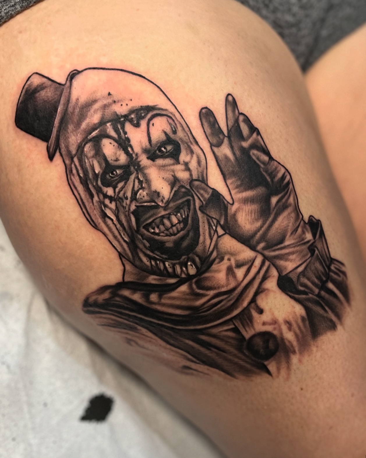 Clown realism tattoo on the thigh by Brittany Welsh, Marlton, New Jersey