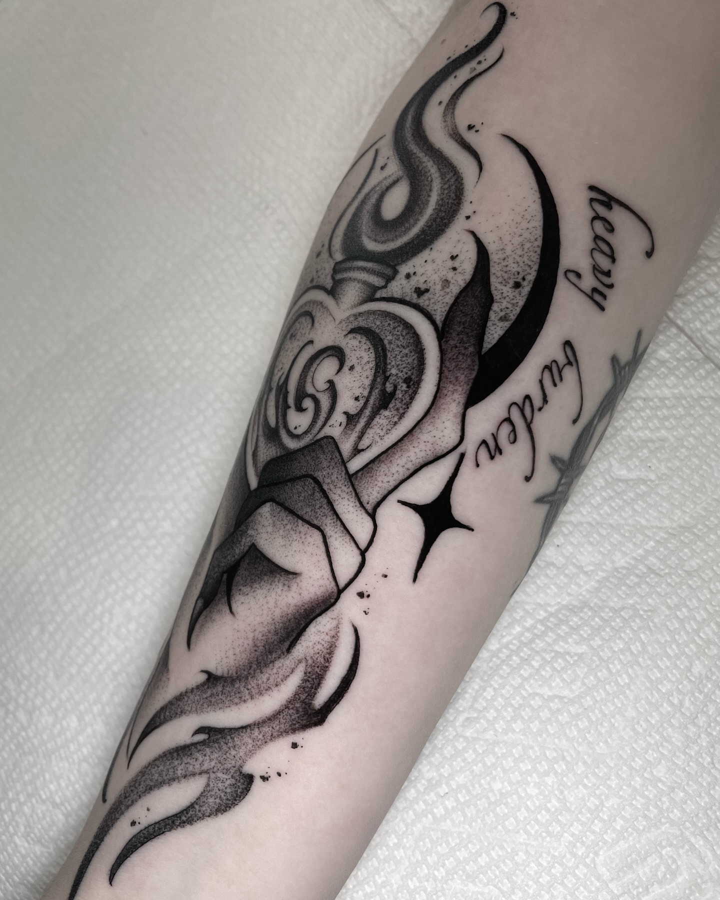 Flame and heart dotwork tattoo on the forearm by Sofia Rose