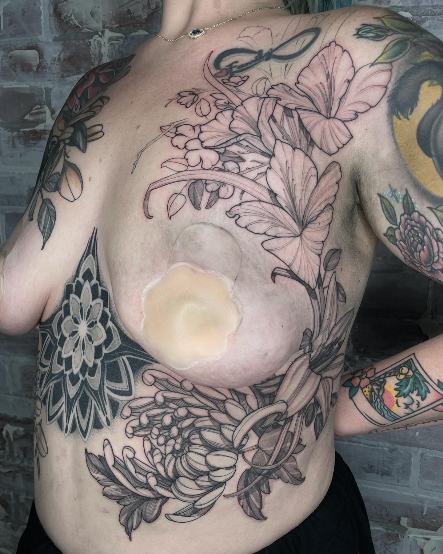 Floral arrangement ornamental tattoo on the chest by Carol Jacky