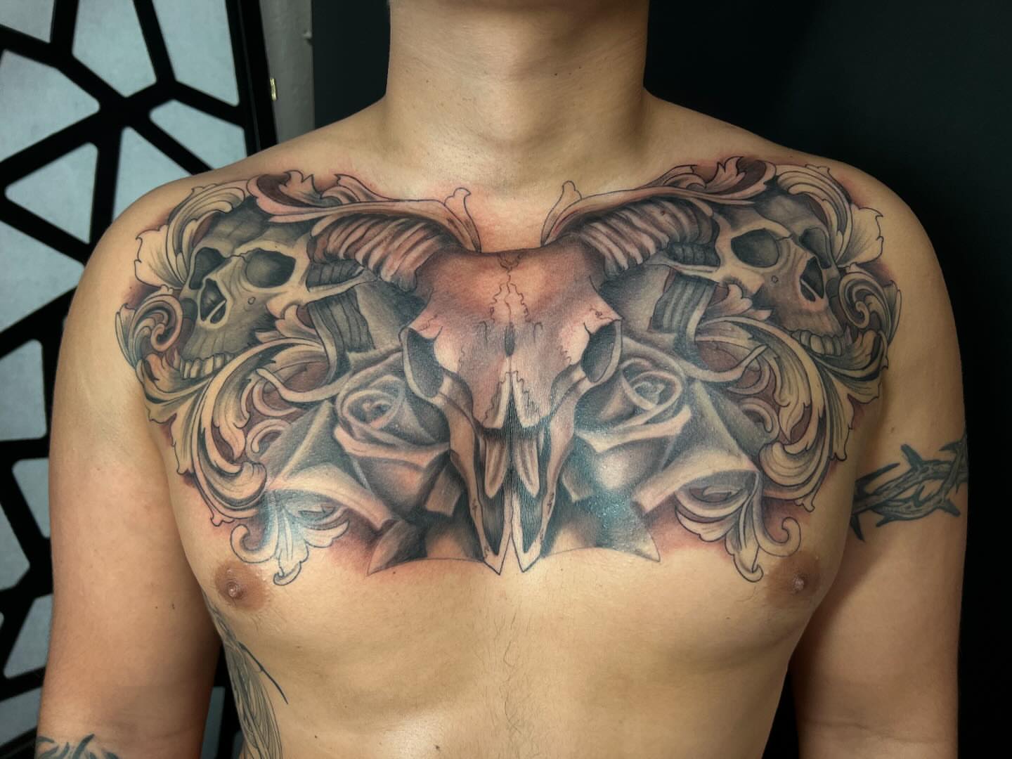 Skulls and roses realism tattoo on the chest by Daphne Landry