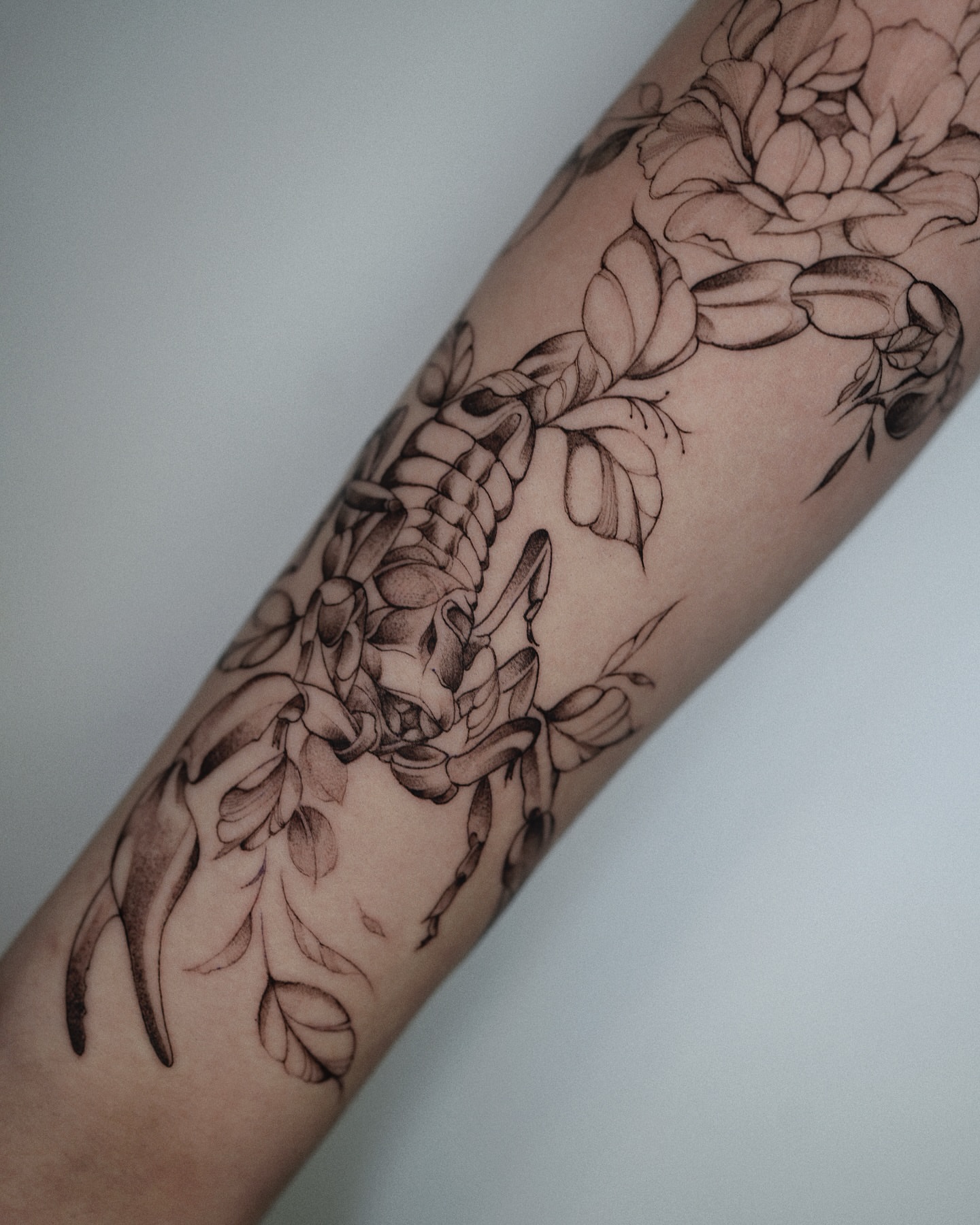Peony and leaves black and grey tattoo on the forearm by @katuvetattoo