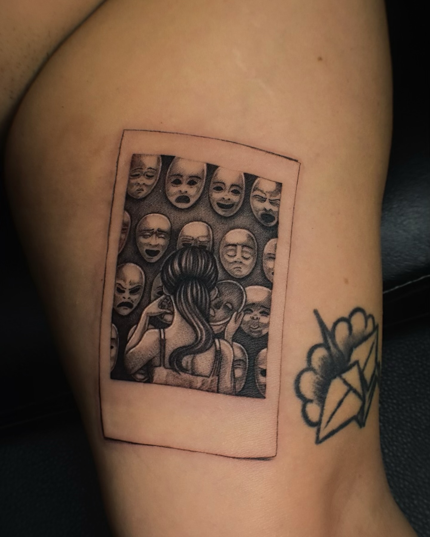 Mask polaroid dotwork tattoo on the thigh by Alexandria Gudiel