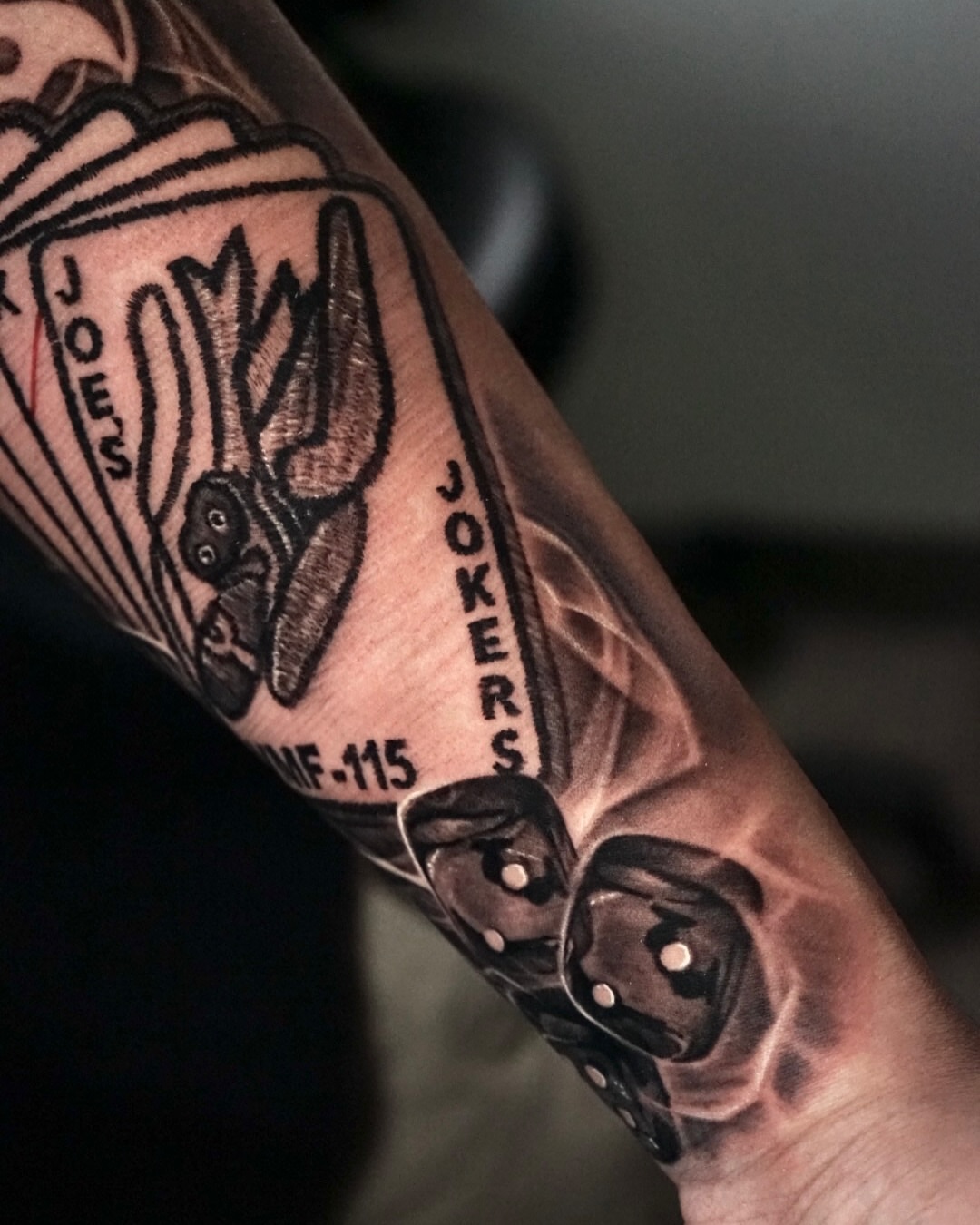 Joker cards realism tattoo on the forearm by Sabrina Lakhaysy, Fort Worth, Texas