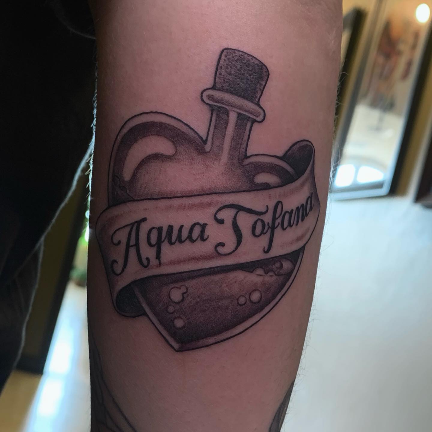 Aqua Tofana black and grey tattoo on the forearm by Tad Fulkerson, San Francisco, California