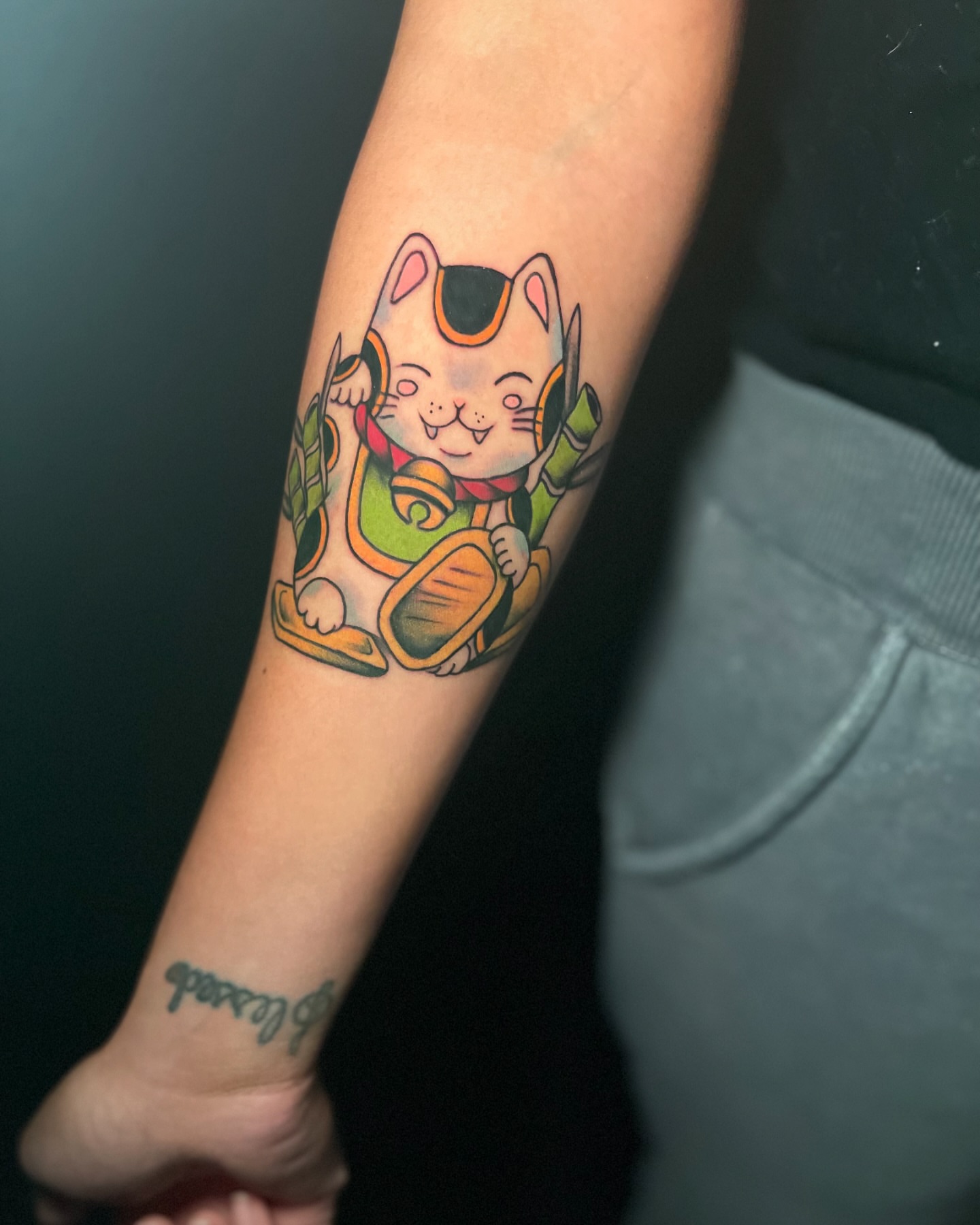 Cat with bell dotwork tattoo on the forearm by Alex