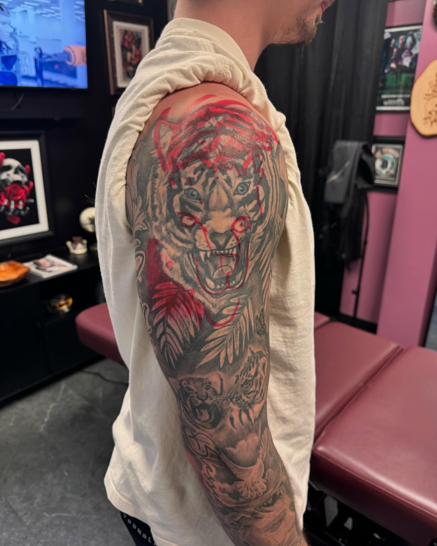 Tiger black and grey tattoo on the upper arm by Chris Lochbihler