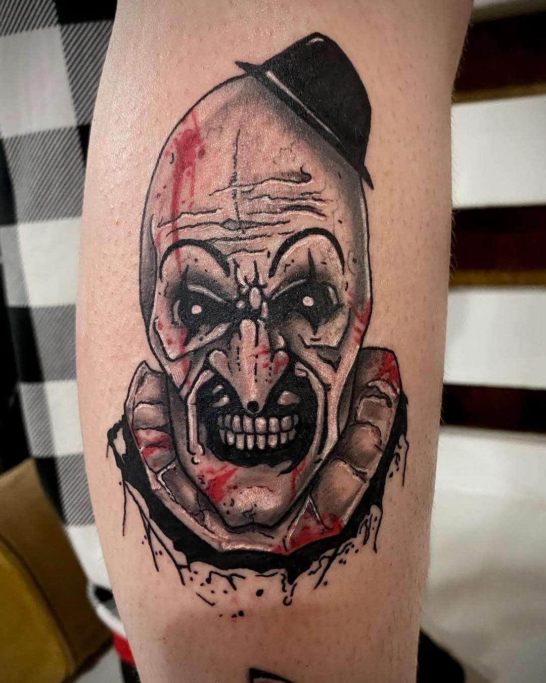 Creepy clown face realism tattoo on the forearm by Rayne