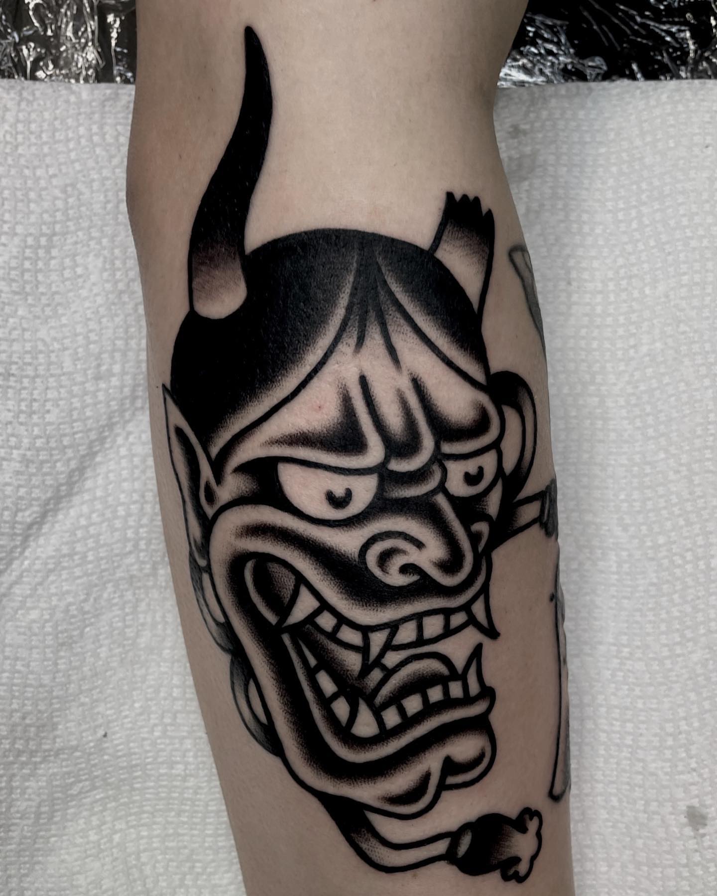 Demon mask black and grey tattoo on the forearm by Jenn ★ Reid