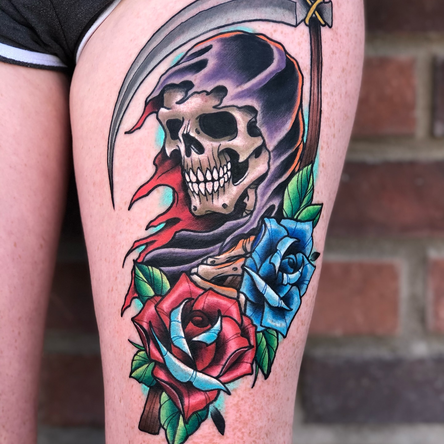 Grim reaper with roses American traditional tattoo on the thigh by James Mullin