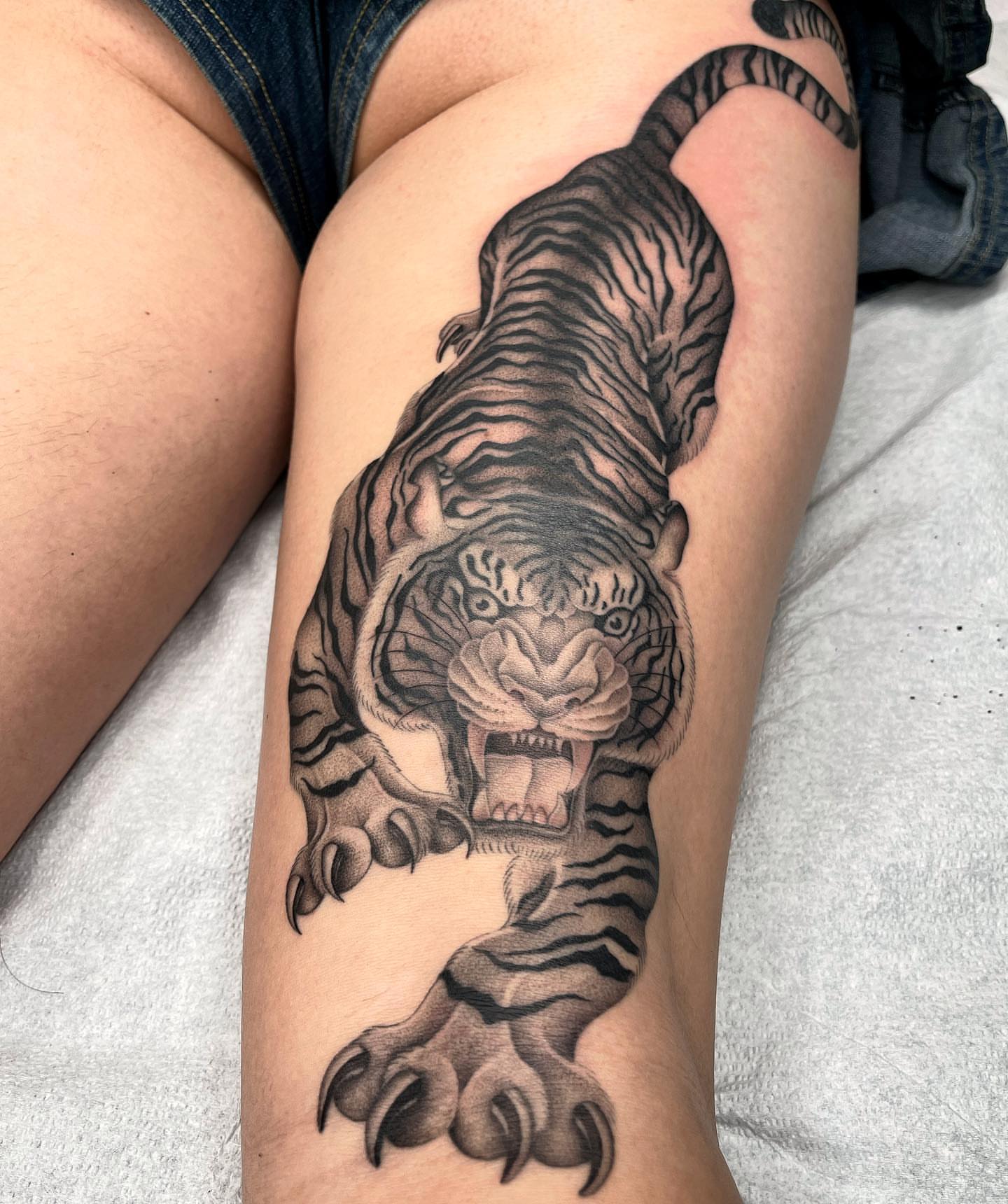Tiger realism tattoo on the thigh by Tiyanna Garlic