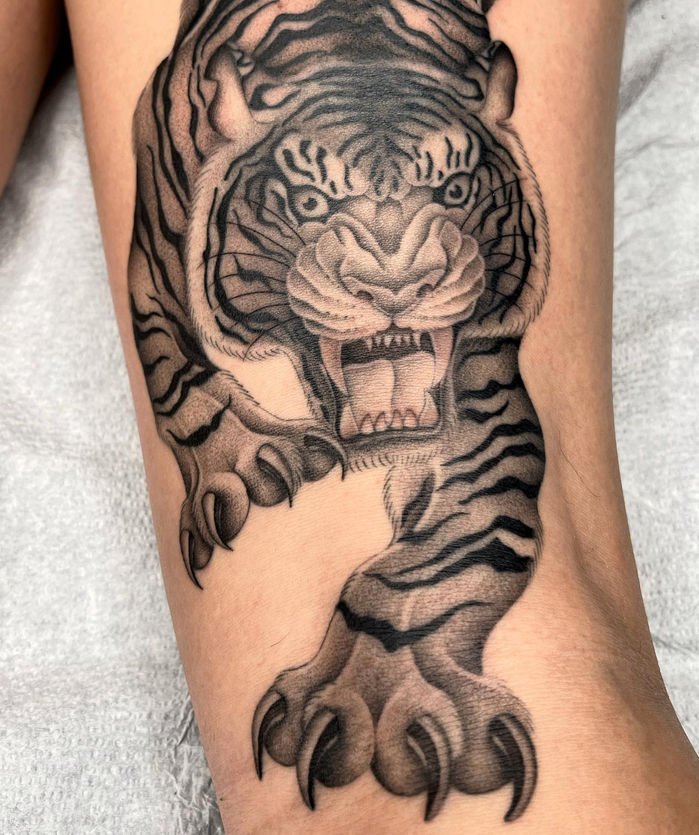 Tiger realism tattoo on the forearm by Tiyanna Garlic