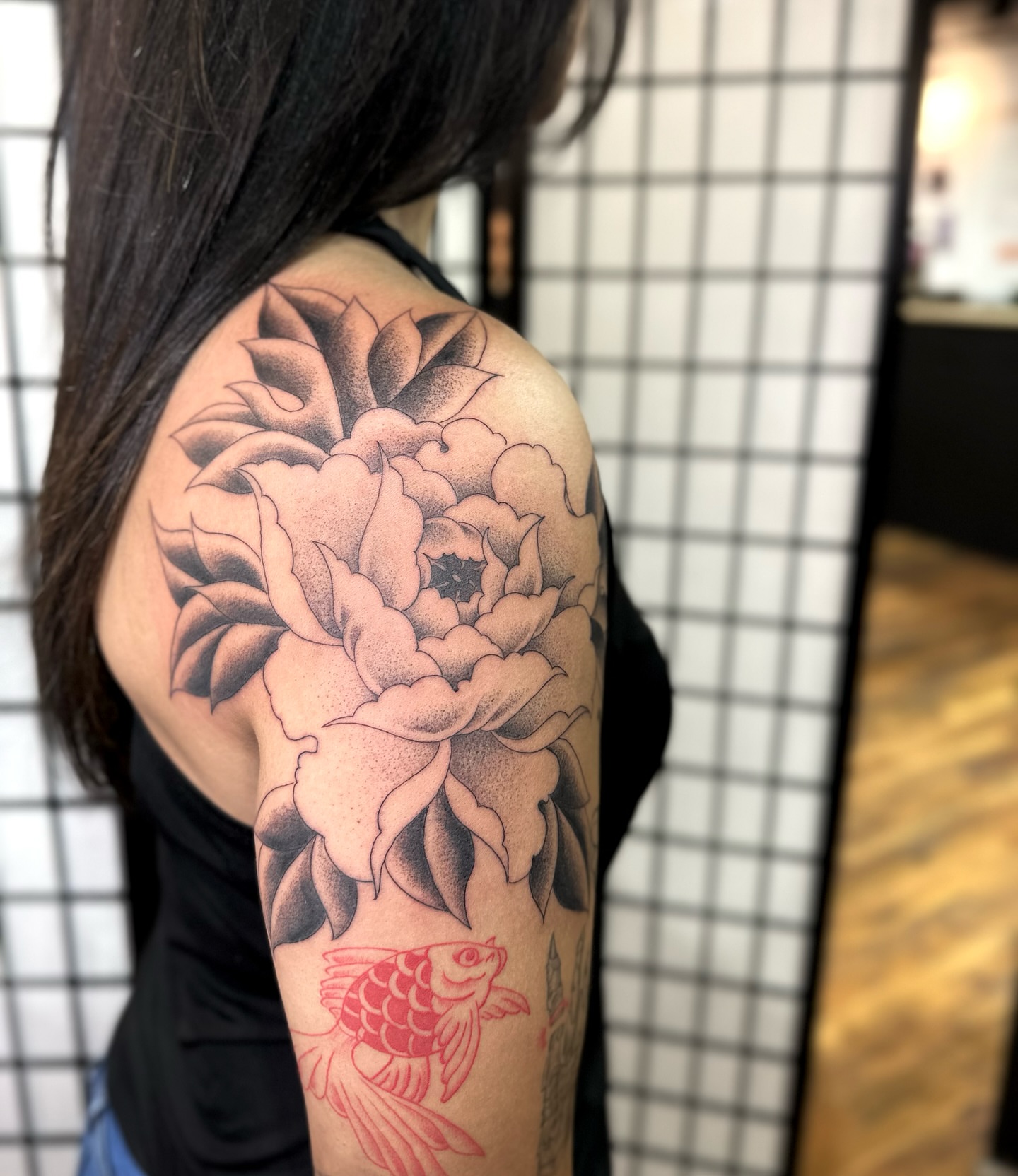 Peony and fish black and grey tattoo on the shoulder by christian martinez