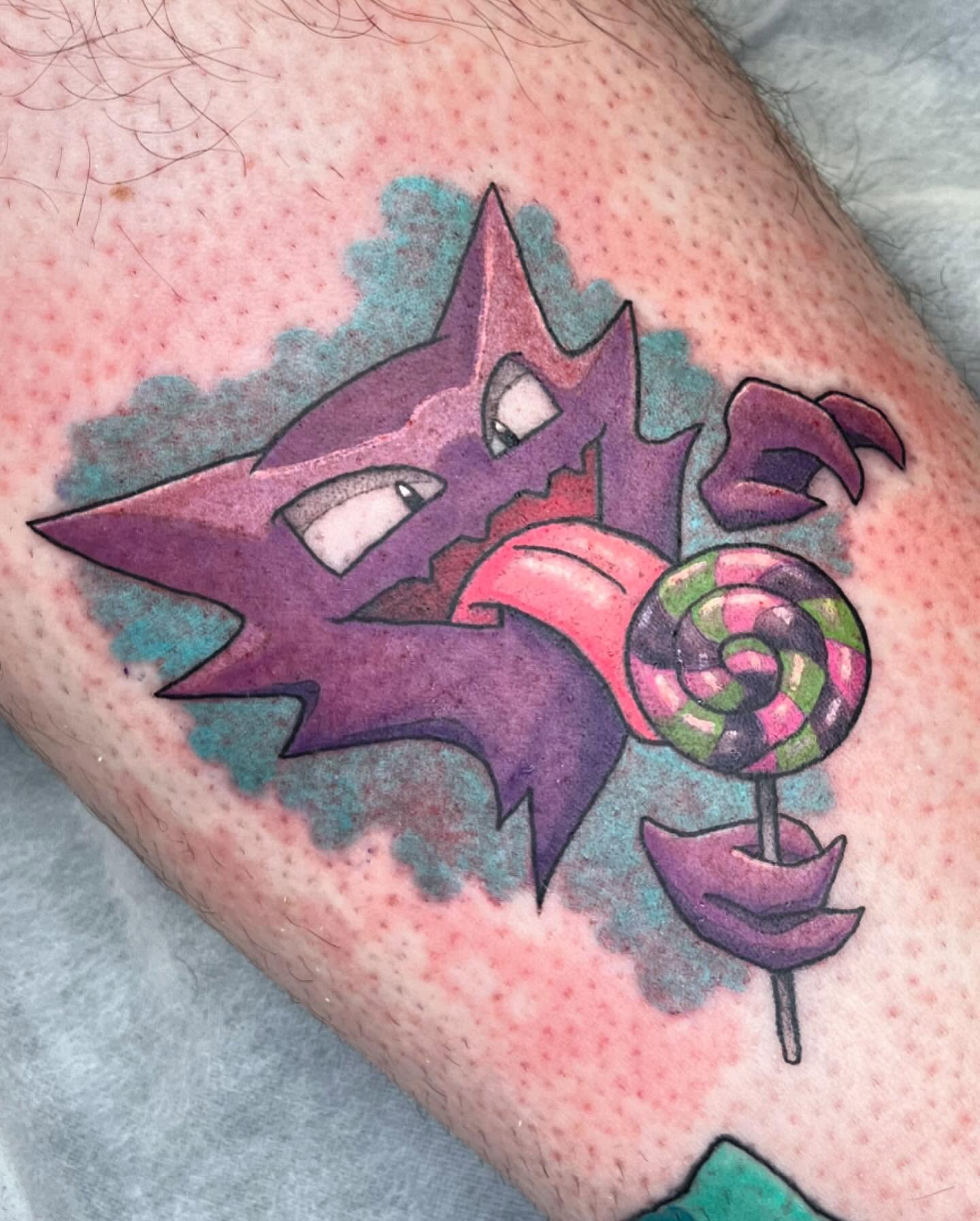 Purple wolf and lollipop geometric tattoo on the forearm by Tattoos by Gina Palladino