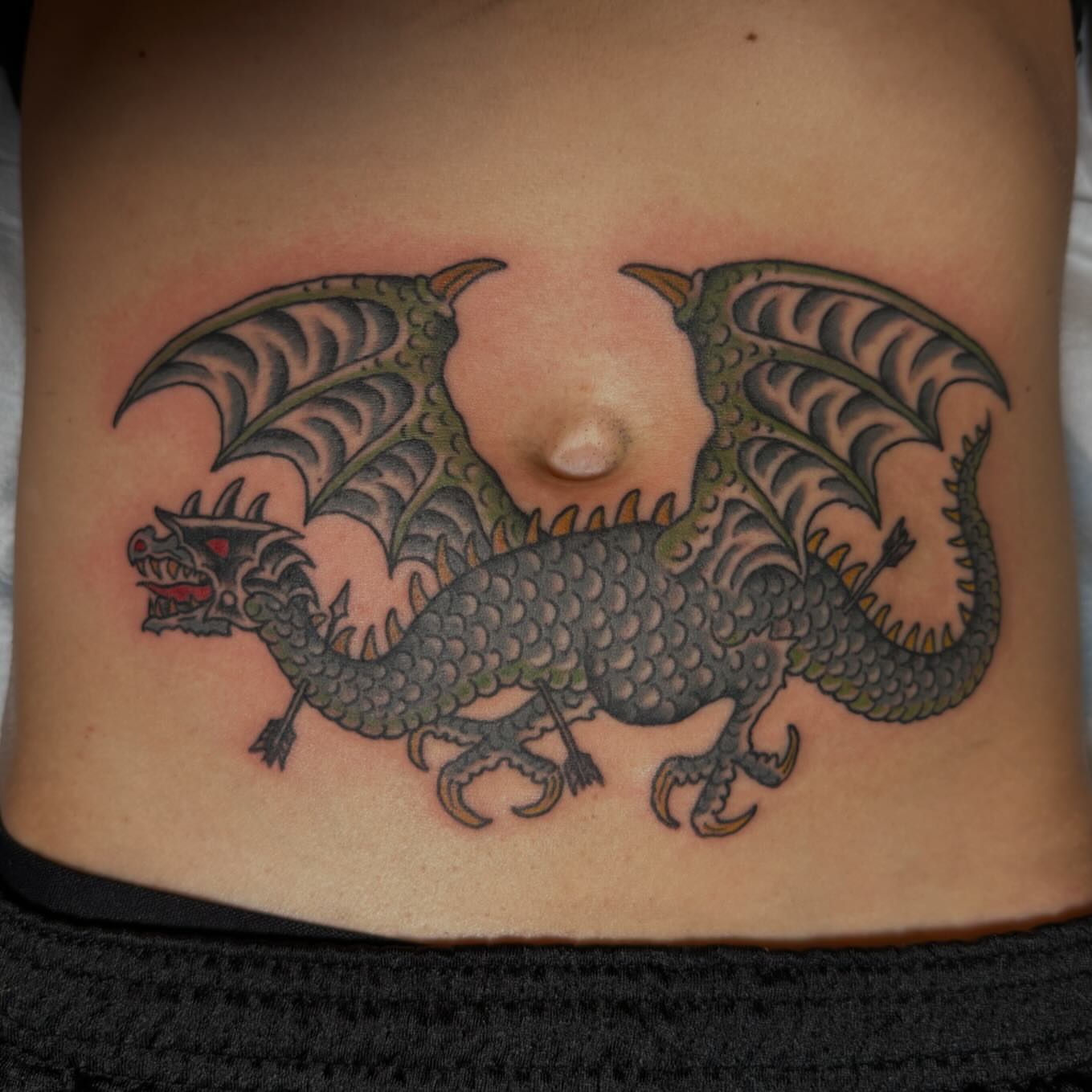 Dragon American traditional tattoo on the ribs by Jesse Swanson, Santa Rosa, California