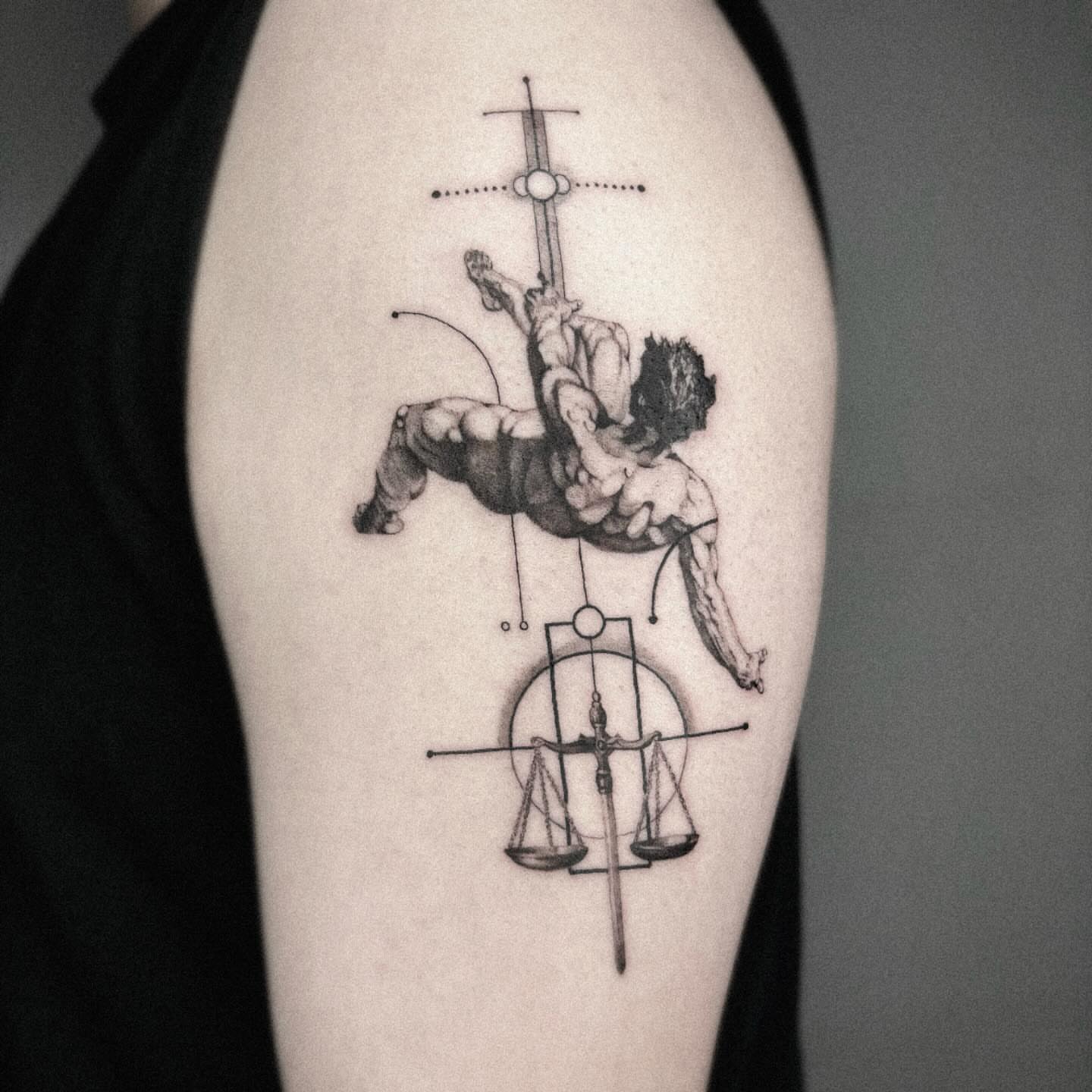 Libra scales and man realism tattoo on the upper arm by Seraph Geometry
