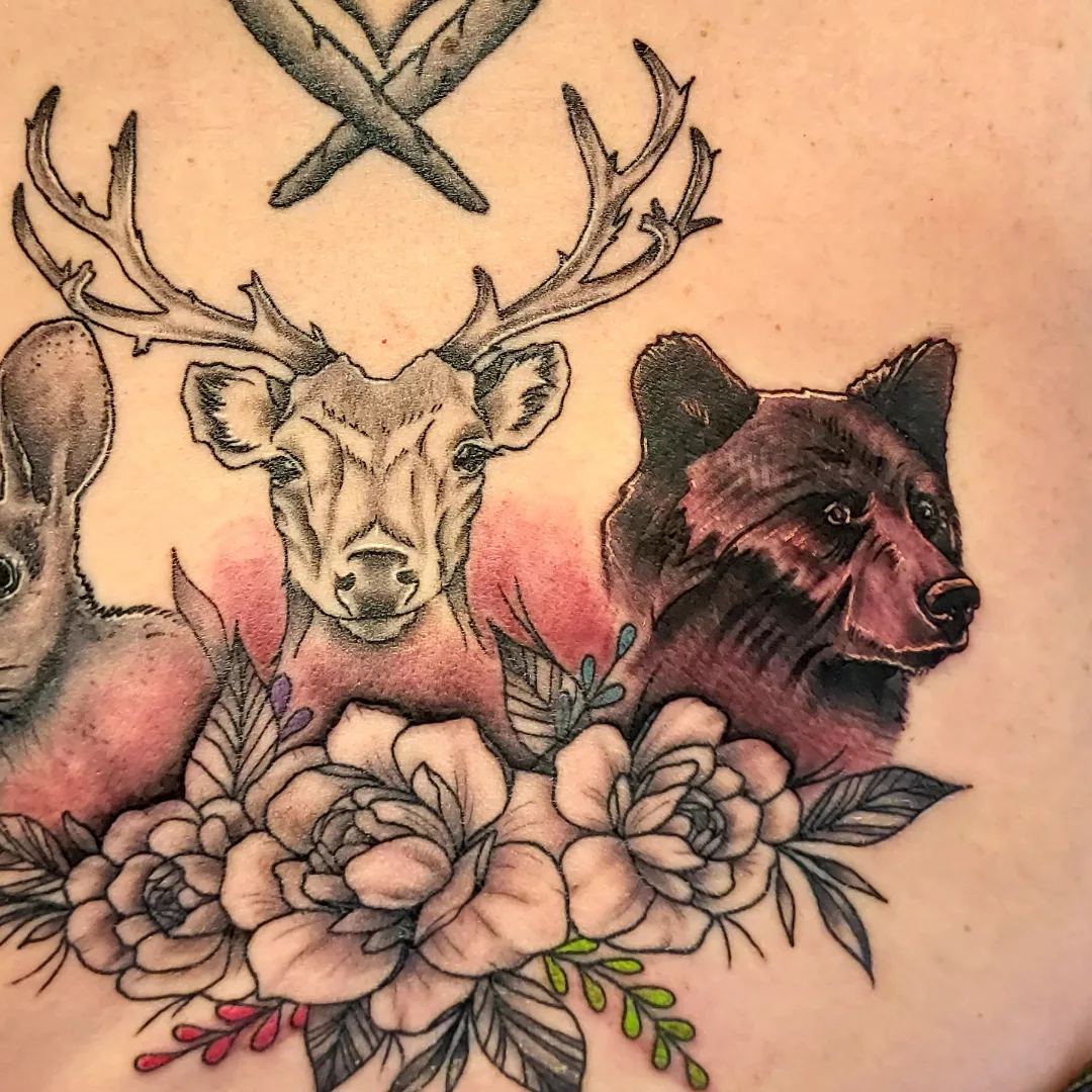 Deer, bear, flowers realism tattoo on the torso by Dave Johnson, Billings, Montana
