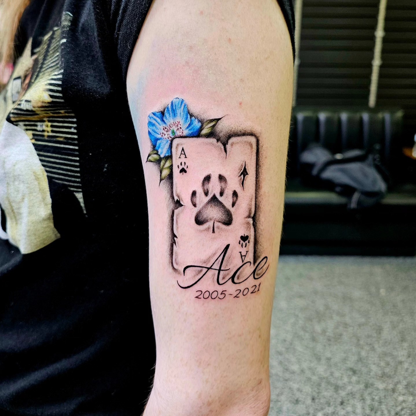Ace card with paw print realism tattoo on the forearm by Drew King