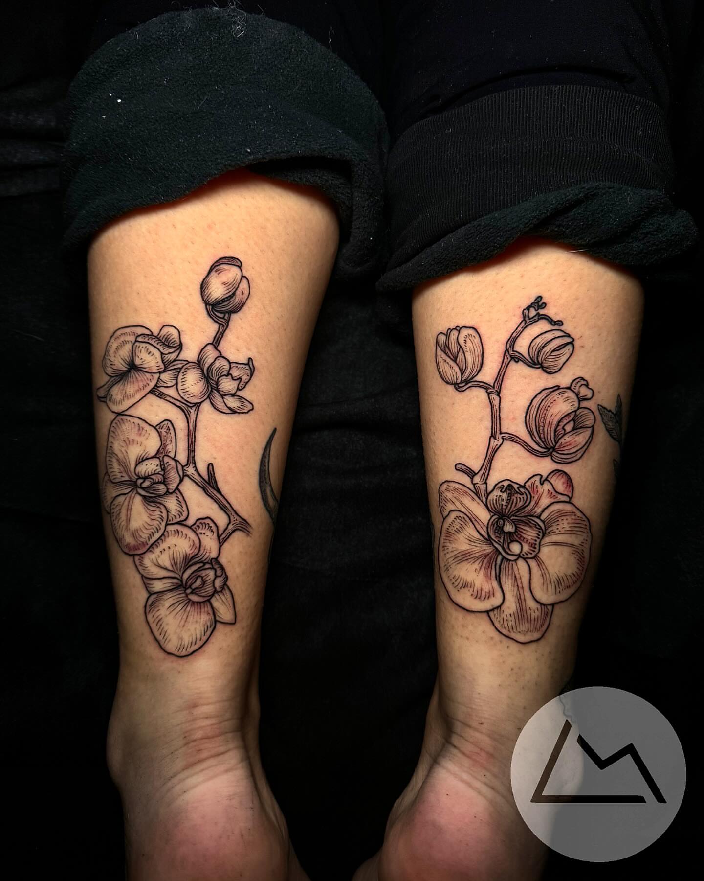 Orchid flowers black and grey tattoo on the forearm by Landon Morgan