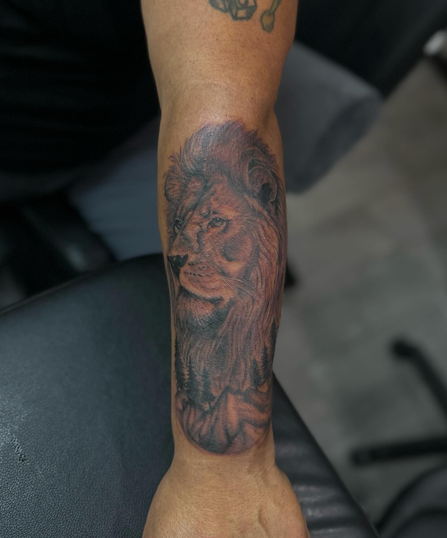 Lion realism tattoo on the forearm by Alexa Camacho