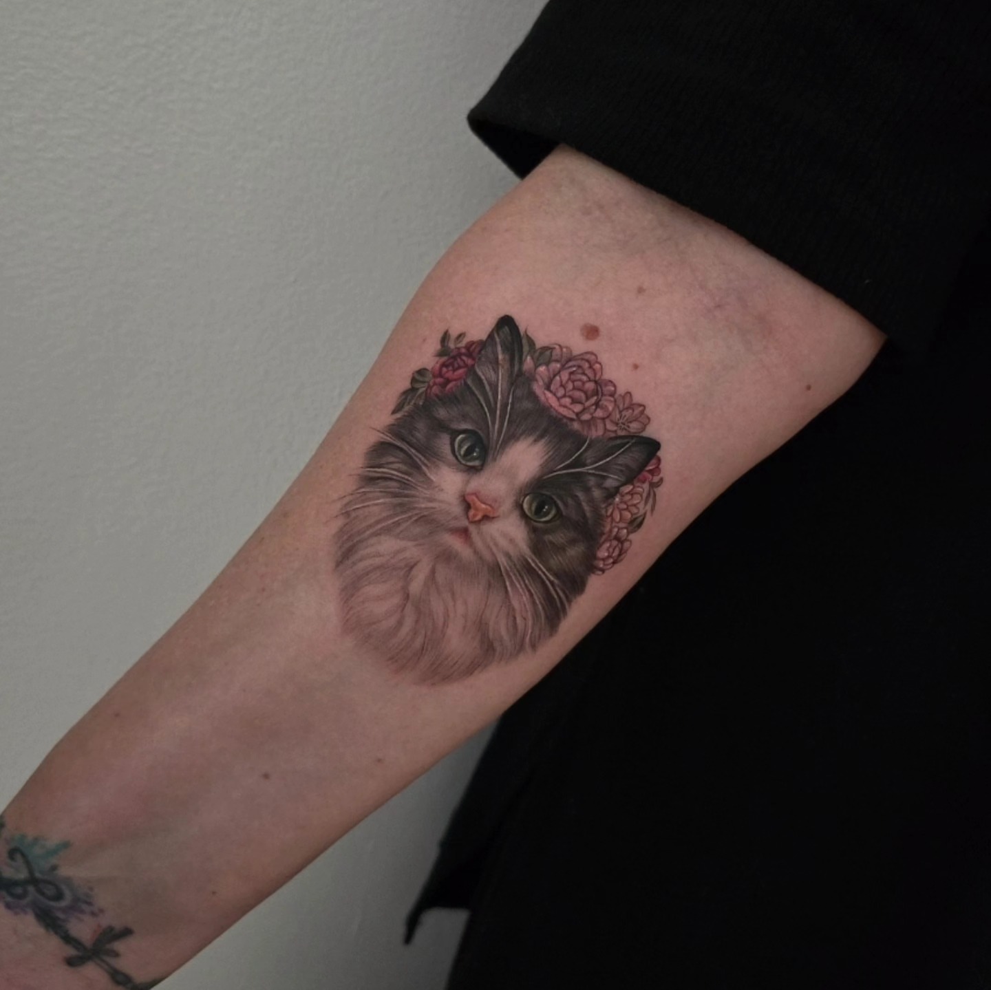 Cat with floral crown realism tattoo on the forearm by Lynx, Cincinnati, Ohio